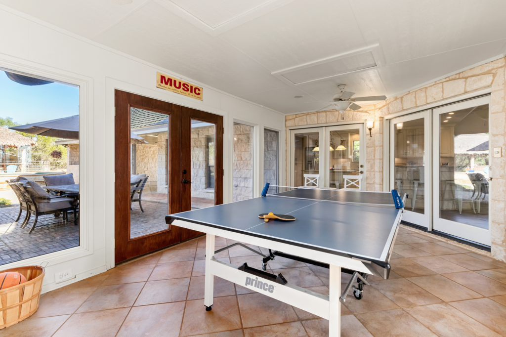 Spacious vacation rental with a ping pong table in a game room, perfect for family fun and connection.