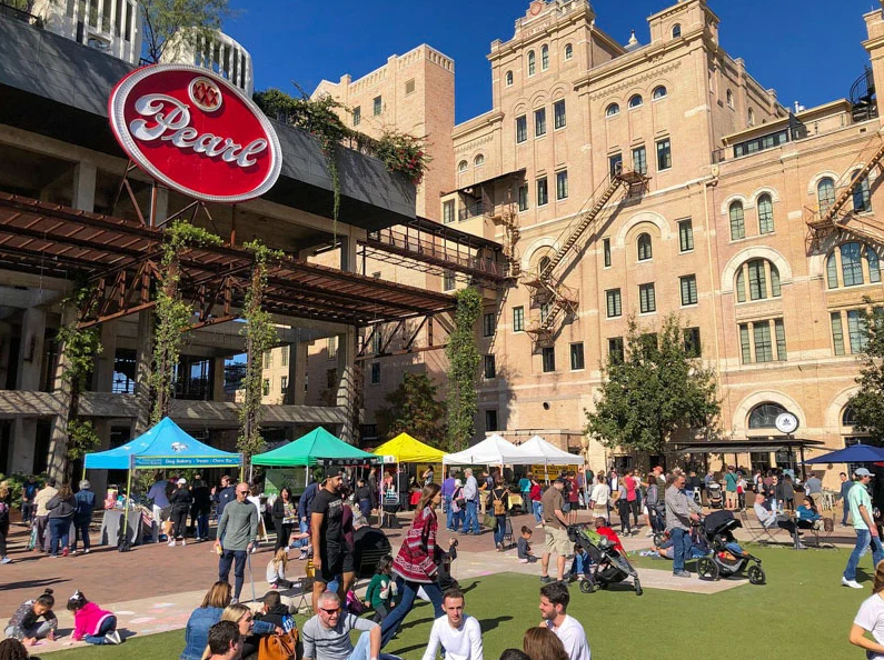 Visitors exploring the Pearl District in San Antonio, highlighting demand for local property management near me vacation rentals.