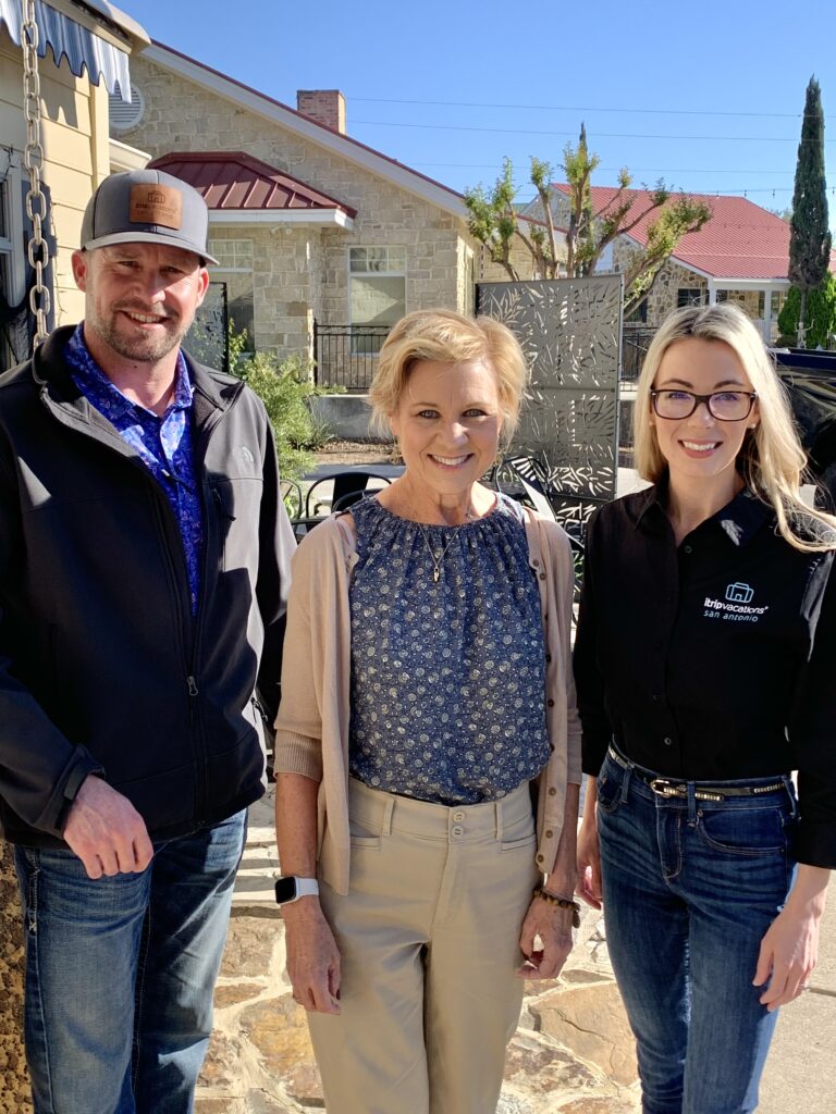 Dustin and Alison Braune, owners of iTrip San Antonio, meeting with a homeowner to discuss professional property management services.