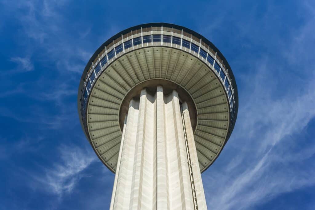 Tower of the Americas in San Antonio against a blue sky, symbolizing local attractions that drive vacation rental demand.