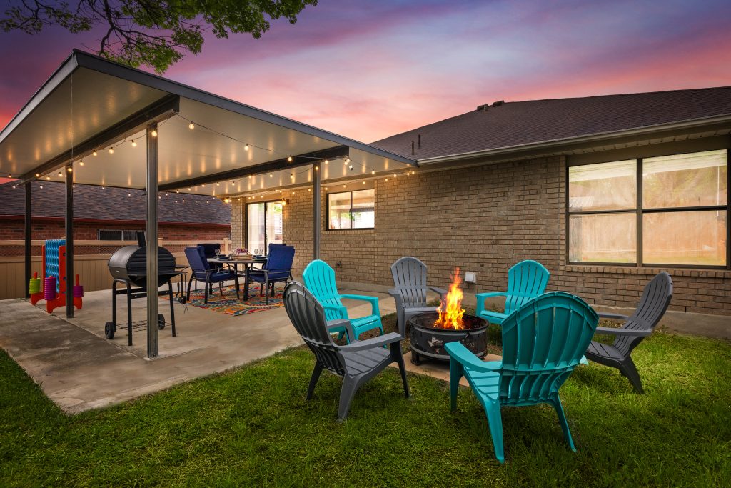 San Antonio vacation rental backyard with fire pit, covered patio, and outdoor seating perfect for relaxing after the Valero Texas Open