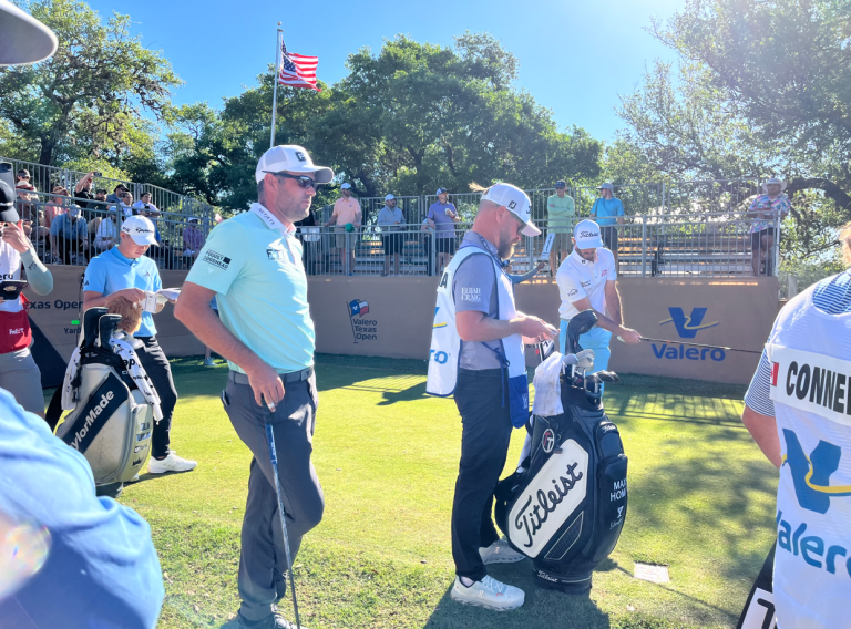 Golfers and caddie on the course at the Valero Texas Open in San Antonio during PGA Tour play